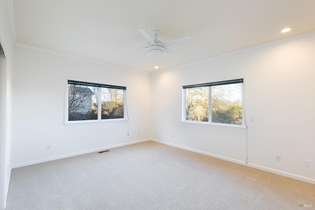 unfurnished room with ornamental molding, visible vents, and light colored carpet