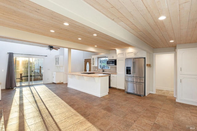 kitchen featuring wood ceiling, a kitchen breakfast bar, stainless steel appliances, white cabinetry, and recessed lighting