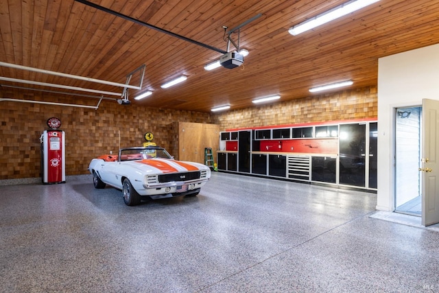 garage with water heater, wood ceiling, and a garage door opener