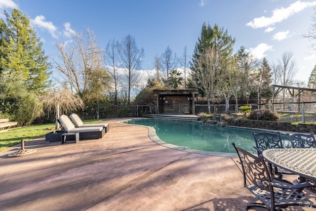 view of swimming pool with a patio area, fence, and a fenced in pool