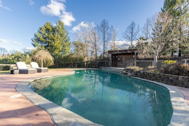 view of swimming pool featuring a fenced in pool, fence, and a patio