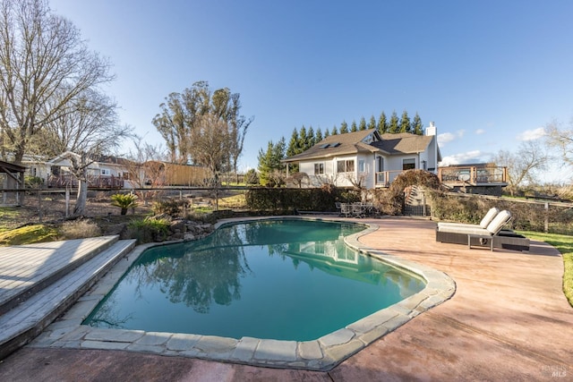 pool featuring fence and a patio