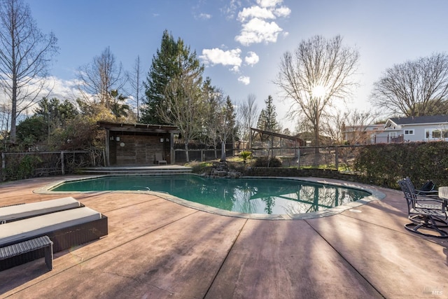 view of pool with a patio area, fence, and a fenced in pool