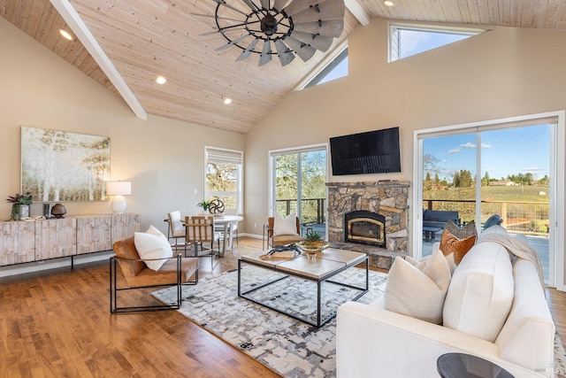 living area with a fireplace, wood ceiling, ceiling fan, wood finished floors, and high vaulted ceiling