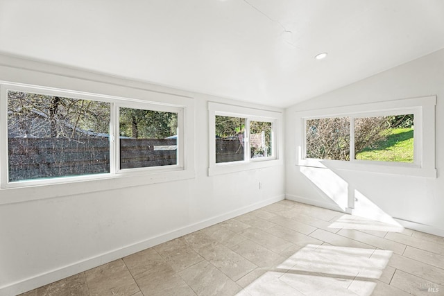 unfurnished sunroom featuring vaulted ceiling