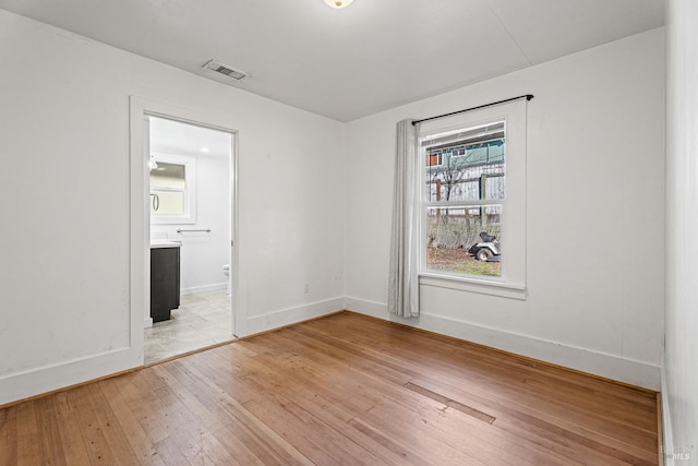 spare room featuring light hardwood / wood-style floors