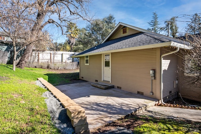 rear view of house with a yard and a patio area