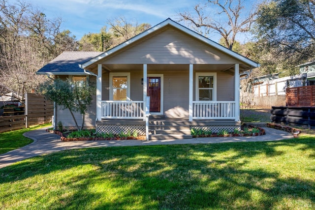 bungalow-style home with a porch and a front lawn