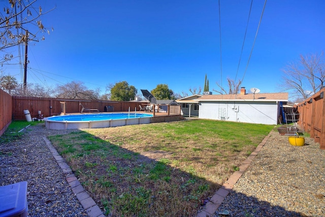 view of yard with a fenced in pool and a fenced backyard