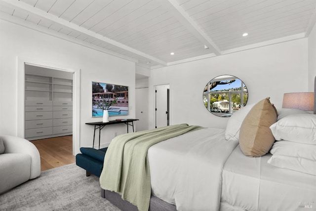 bedroom featuring hardwood / wood-style floors, wood ceiling, and beam ceiling