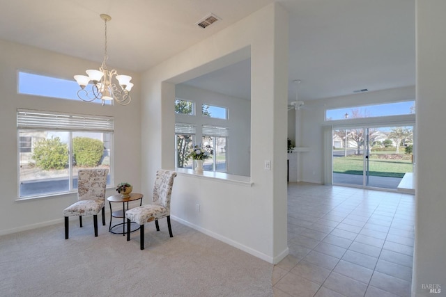 sitting room featuring ceiling fan with notable chandelier, light tile patterned floors, and a wealth of natural light