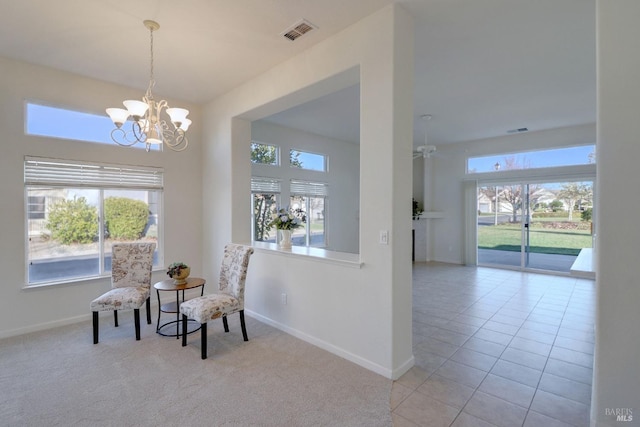 living area with baseboards, a notable chandelier, tile patterned flooring, and visible vents
