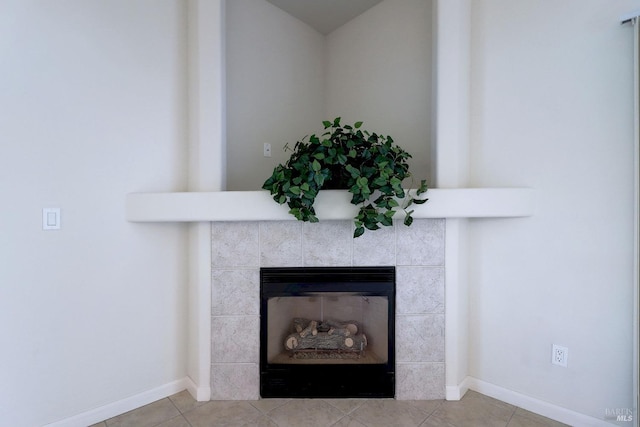 interior details featuring a tiled fireplace