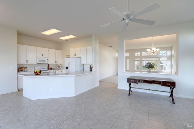 kitchen featuring white appliances, white cabinetry, hanging light fixtures, ceiling fan with notable chandelier, and kitchen peninsula