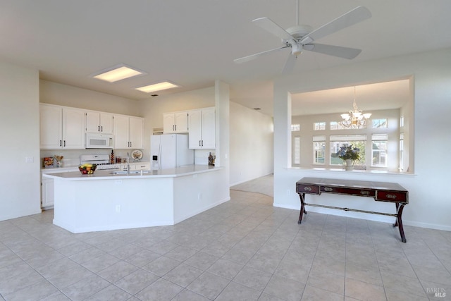 kitchen with ceiling fan with notable chandelier, light countertops, white appliances, and white cabinetry