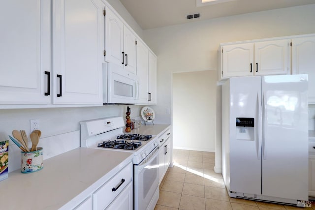 kitchen featuring light countertops, visible vents, white cabinetry, and white appliances