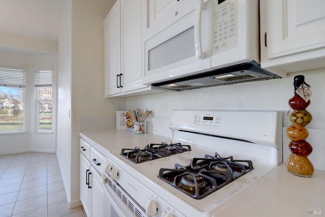 kitchen featuring white cabinetry, white appliances, and light countertops
