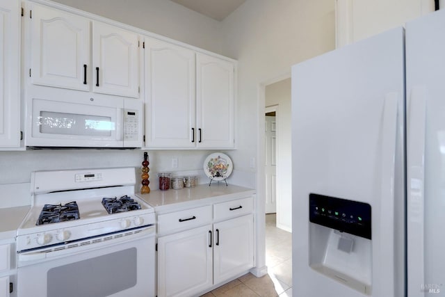 kitchen featuring white cabinetry, light tile patterned flooring, white appliances, and light countertops