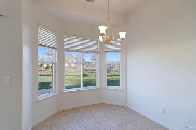 unfurnished dining area featuring baseboards, a notable chandelier, and light tile patterned floors