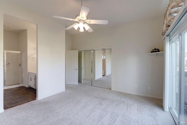 unfurnished bedroom with a ceiling fan, a closet, ensuite bath, baseboards, and carpet flooring
