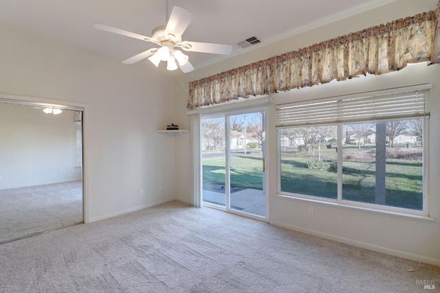 empty room with baseboards, a ceiling fan, visible vents, and carpet floors