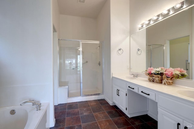 full bath with a bath, a sink, double vanity, and a stall shower