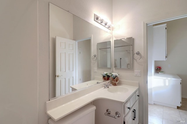 bathroom featuring tile patterned flooring and vanity