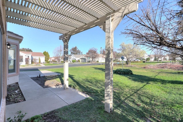 view of yard featuring a pergola and a residential view