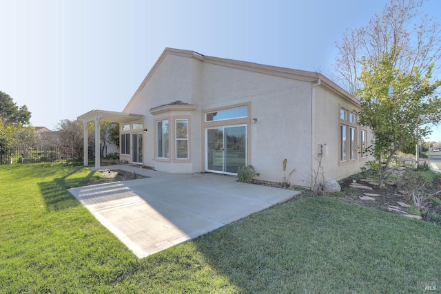 back of property with a pergola, a yard, and a patio area