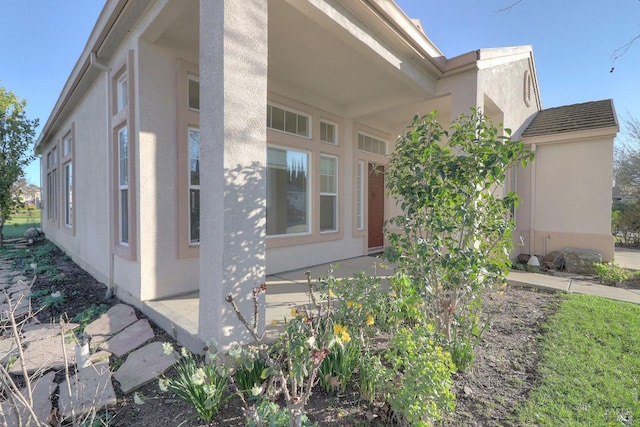 view of side of property with stucco siding