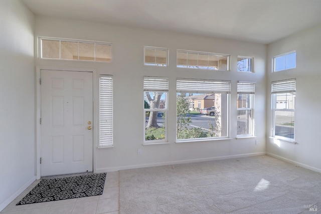 foyer entrance featuring light colored carpet