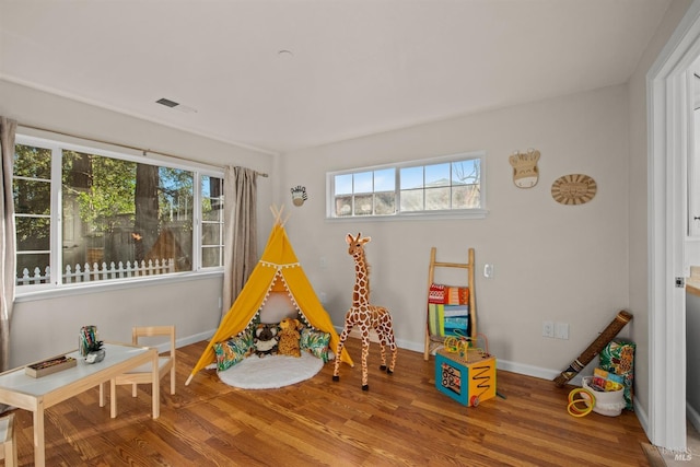 game room with visible vents, baseboards, and wood finished floors