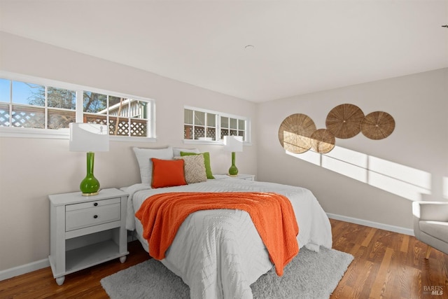 bedroom featuring baseboards and wood finished floors