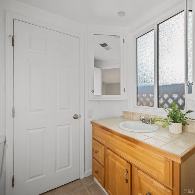 bathroom featuring tile patterned flooring, visible vents, and vanity