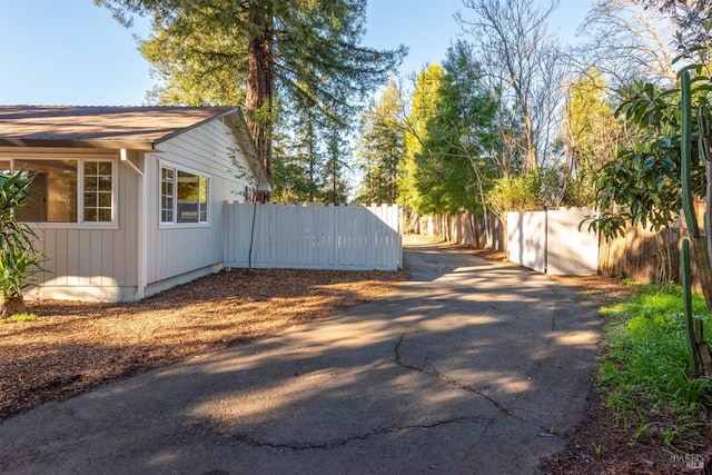 view of side of home featuring a fenced backyard