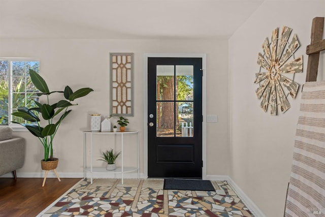 entrance foyer featuring wood finished floors and baseboards