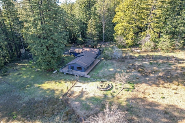 view of storm shelter featuring a wooded view