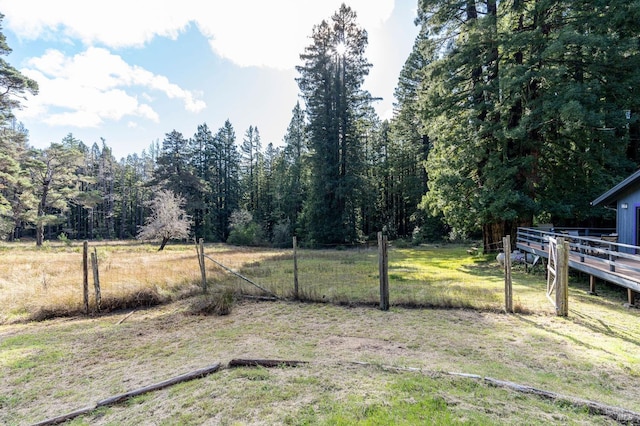 view of yard with fence and a deck
