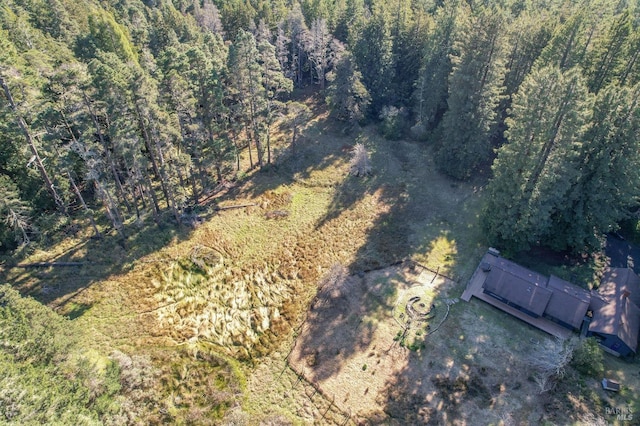 birds eye view of property with a view of trees