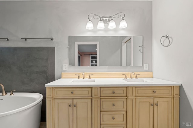 full bathroom featuring double vanity, a freestanding tub, and a sink