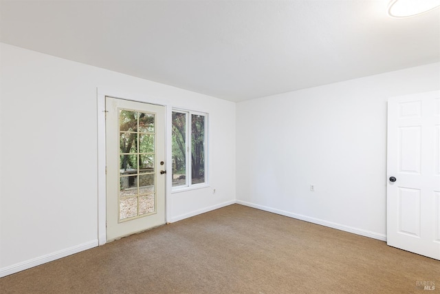 unfurnished room with light colored carpet