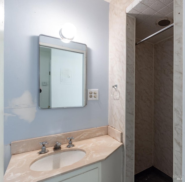 bathroom featuring vanity, electric panel, and tiled shower