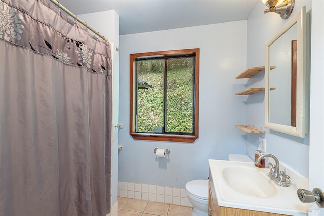 bathroom with tile patterned flooring, vanity, and toilet