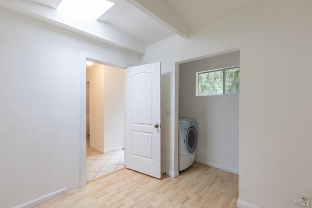 laundry area featuring washer / clothes dryer and light wood-type flooring