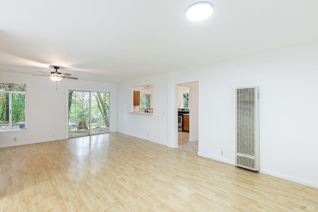 spare room with light hardwood / wood-style floors and ceiling fan