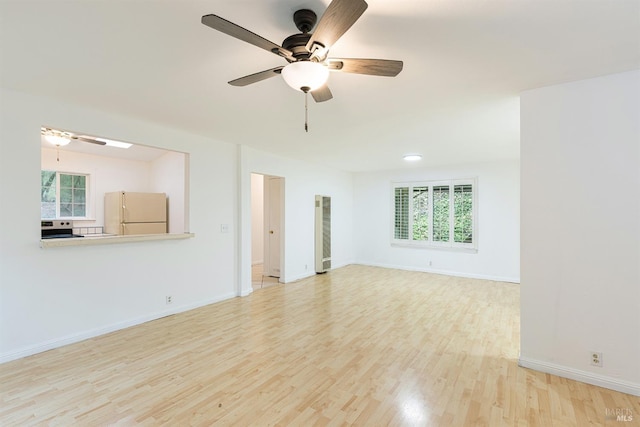 unfurnished living room featuring ceiling fan and light wood-type flooring