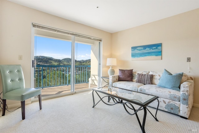 carpeted living room featuring a mountain view