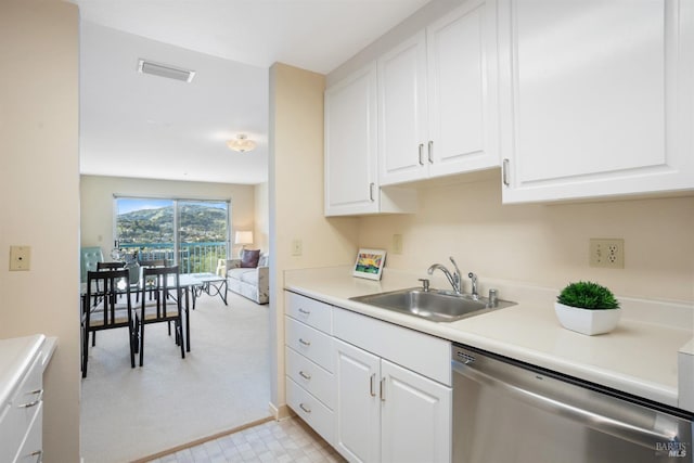 kitchen featuring white cabinetry, stainless steel dishwasher, and sink