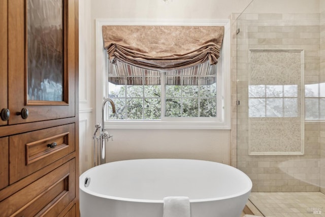 bathroom featuring shower with separate bathtub