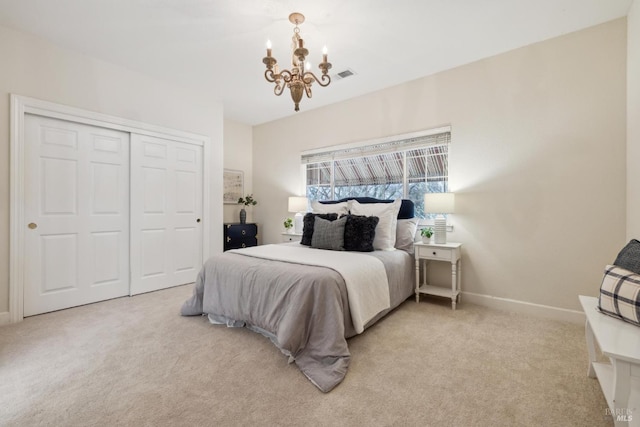 carpeted bedroom featuring a notable chandelier and a closet